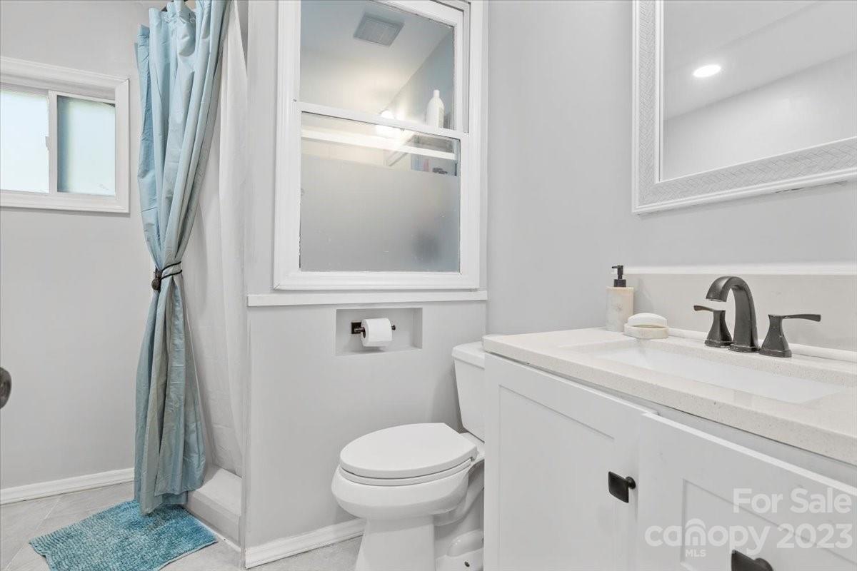 9099 Pitcairn Drive Tega Cay, SC 29708 - Photo 13 of 21 a bathroom with a sink toilet and a mirror