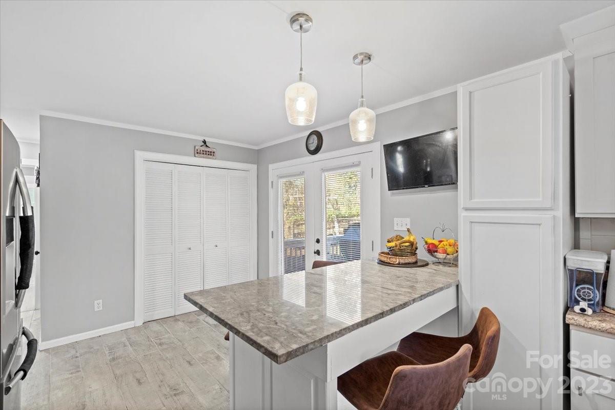 9099 Pitcairn Drive Tega Cay, SC 29708 - Photo 7 of 21 a kitchen with stainless steel appliances granite countertop a stove a sink dishwasher and a microwave with wooden floor
