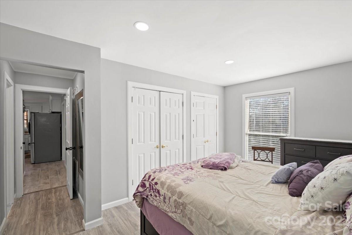 9099 Pitcairn Drive Tega Cay, SC 29708 - Photo 10 of 21 a bedroom with a bed and wooden floor