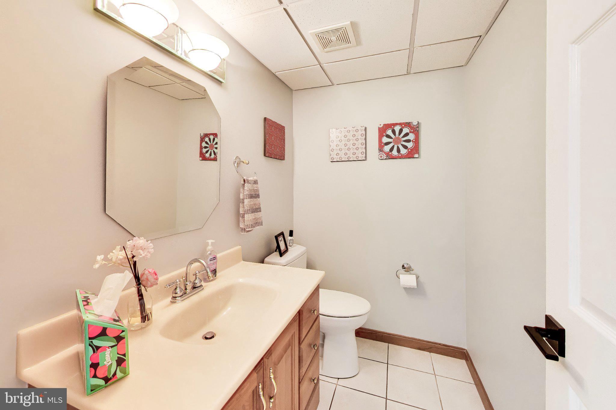 14216 Alderton Road Silver Spring, MD 20906 - Photo 29 of 63 a bathroom with a sink mirror vanity and toilet