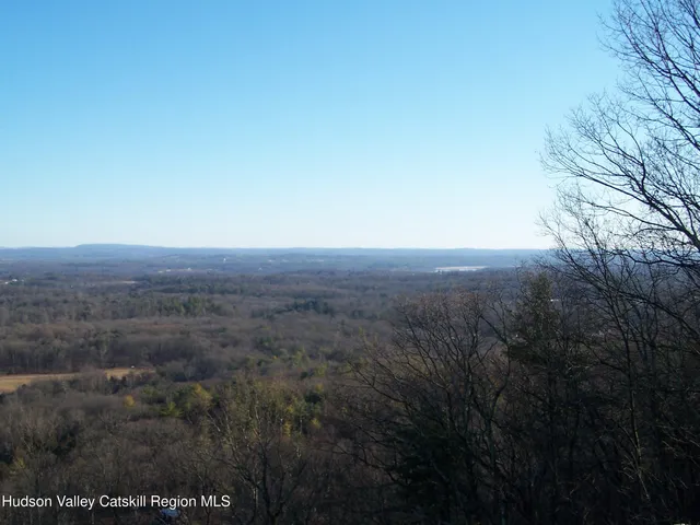 a view of a street with trees on both side of it