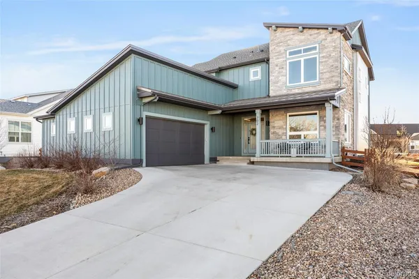 a view of a house with backyard and parking