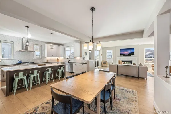 a large kitchen with a table and chairs