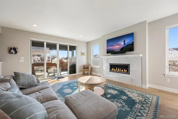 a living room with furniture a fireplace and a flat screen tv