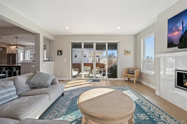 a living room with furniture a fireplace and a flat screen tv