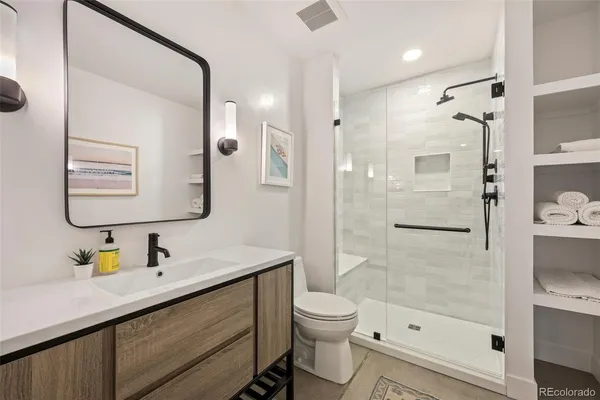 a bathroom with a sink toilet and shower