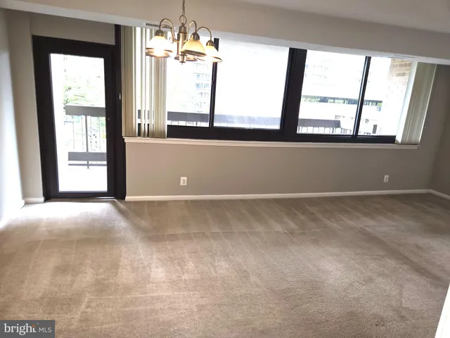 a view of a room with furniture and a large window