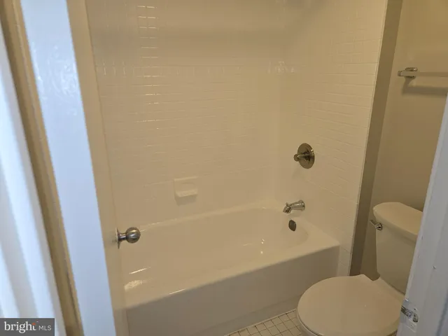 a spacious bathroom with a double vanity sink a large mirror and a shower