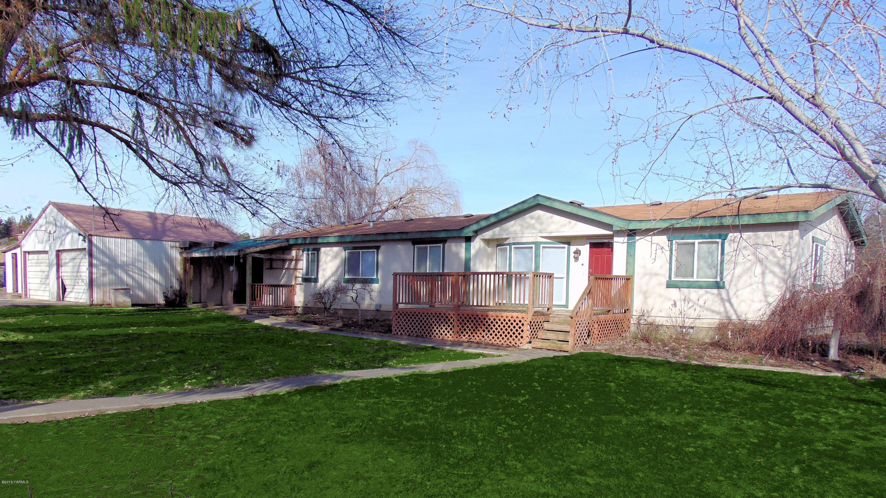 151 Cook Road Yakima, WA 98908 - Photo 1 of 13 a view of a house with a yard