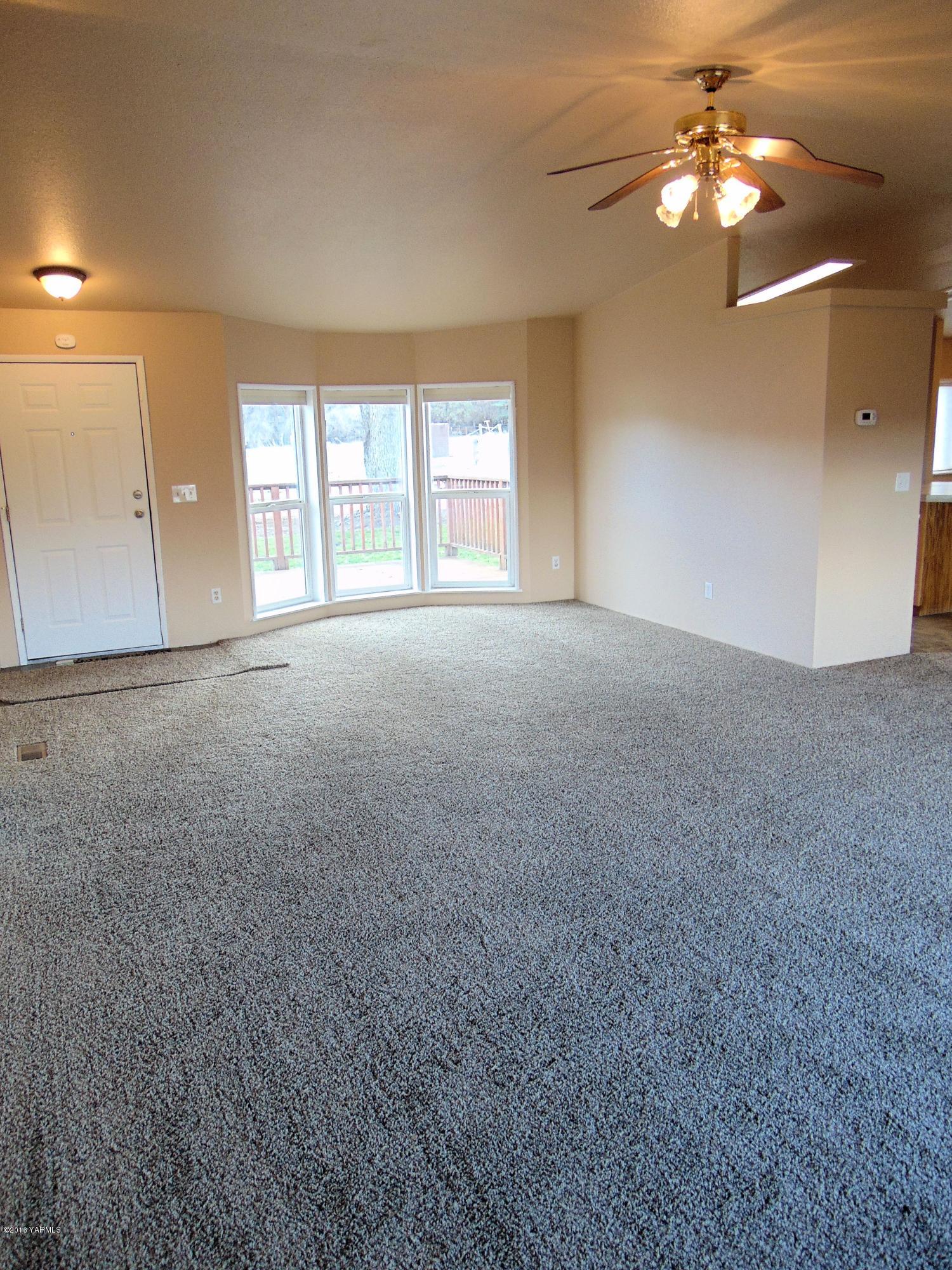 151 Cook Road Yakima, WA 98908 - Photo 5 of 13 a view of a big room with chandelier fan and windows