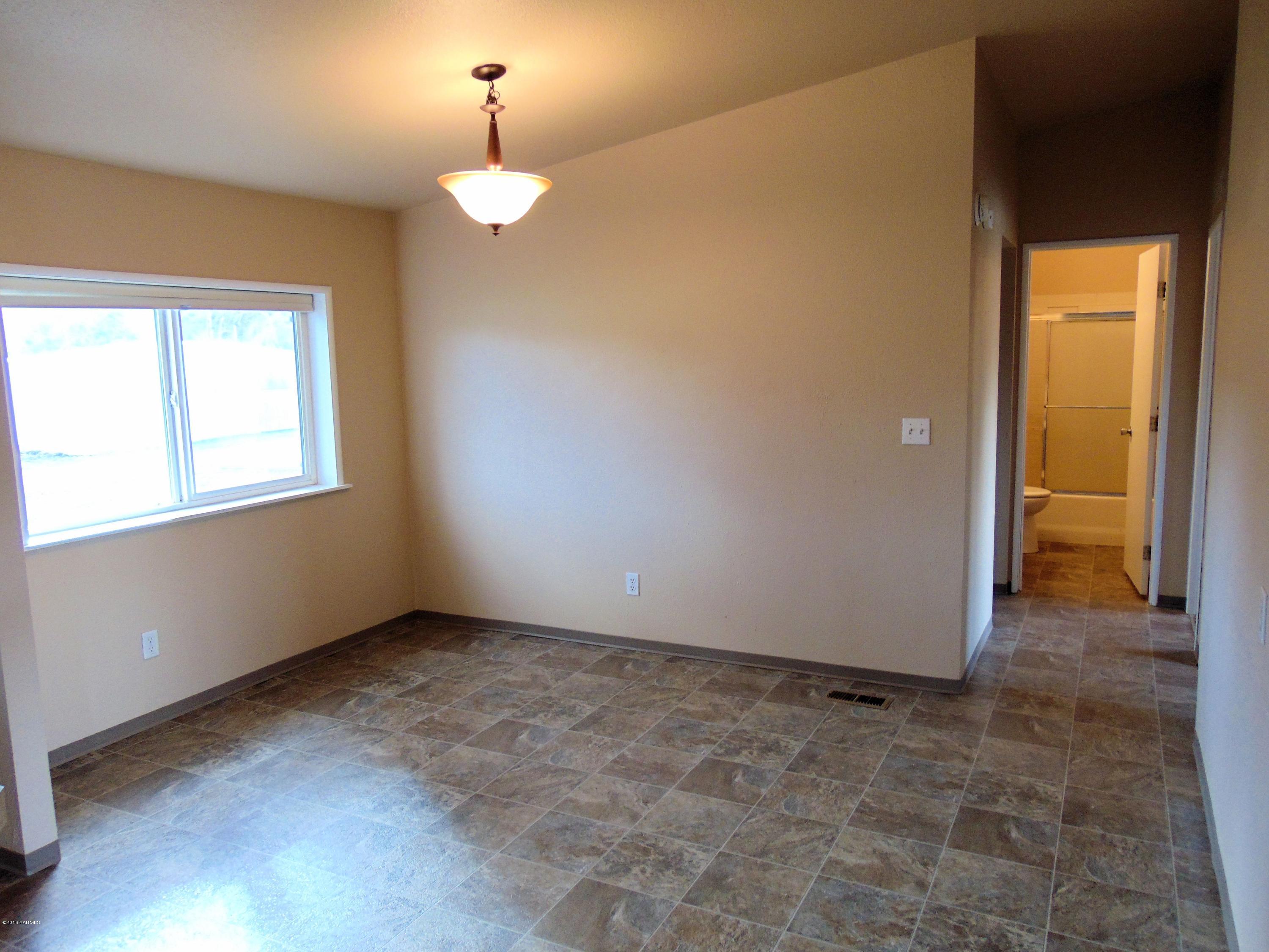 151 Cook Road Yakima, WA 98908 - Photo 6 of 13 a view of an empty room with glass door