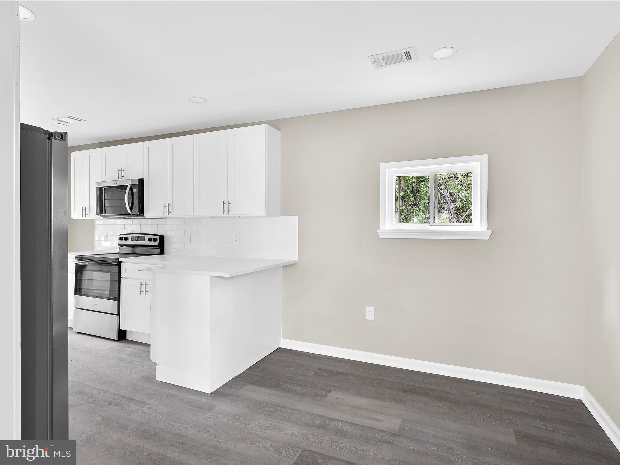 360 Nottingham Road Elkton, MD 21921 - Photo 10 of 32 a kitchen with white cabinets and appliances