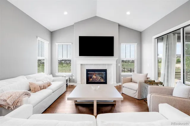 a living room with furniture fireplace and window