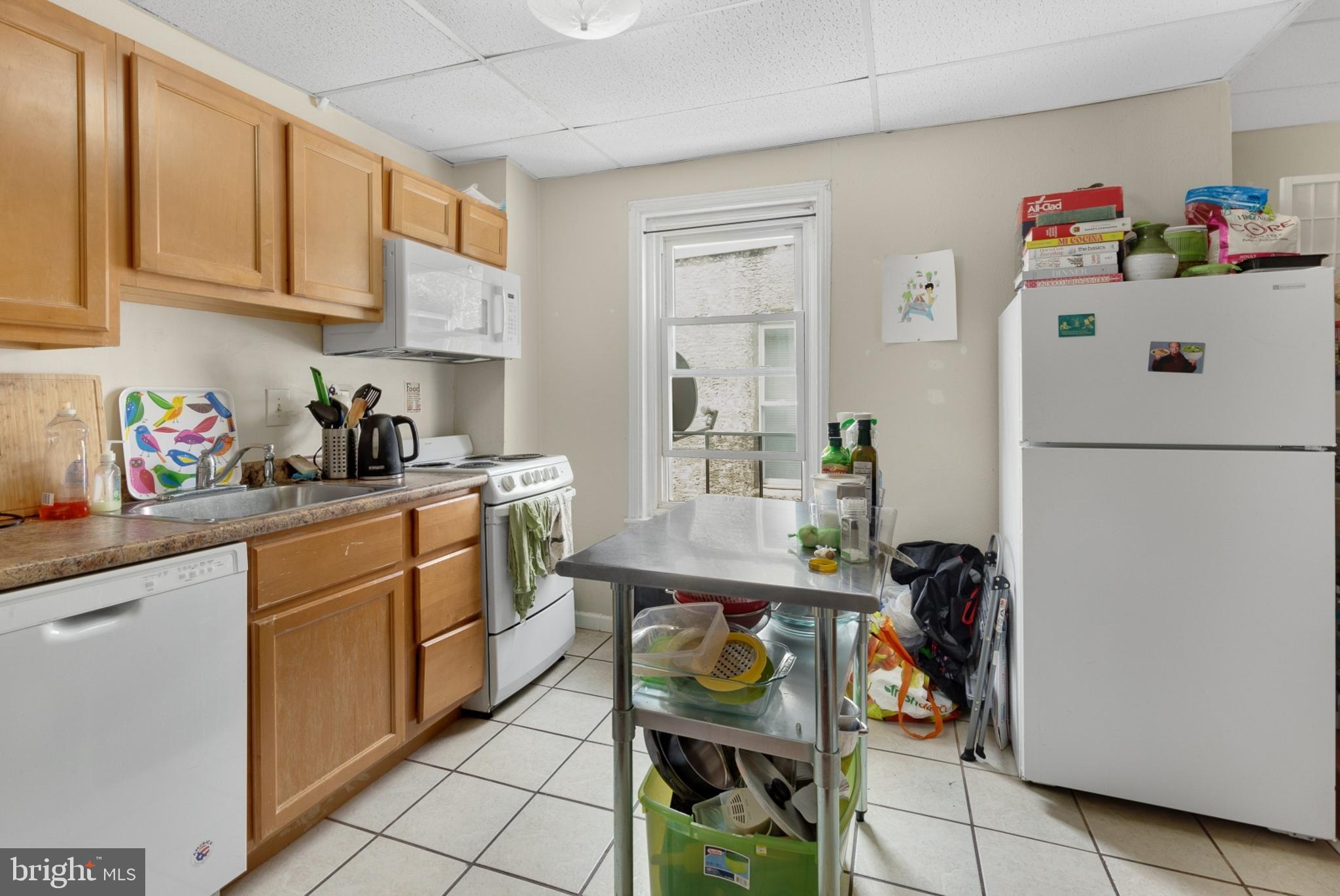 a kitchen with a refrigerator and cabinets