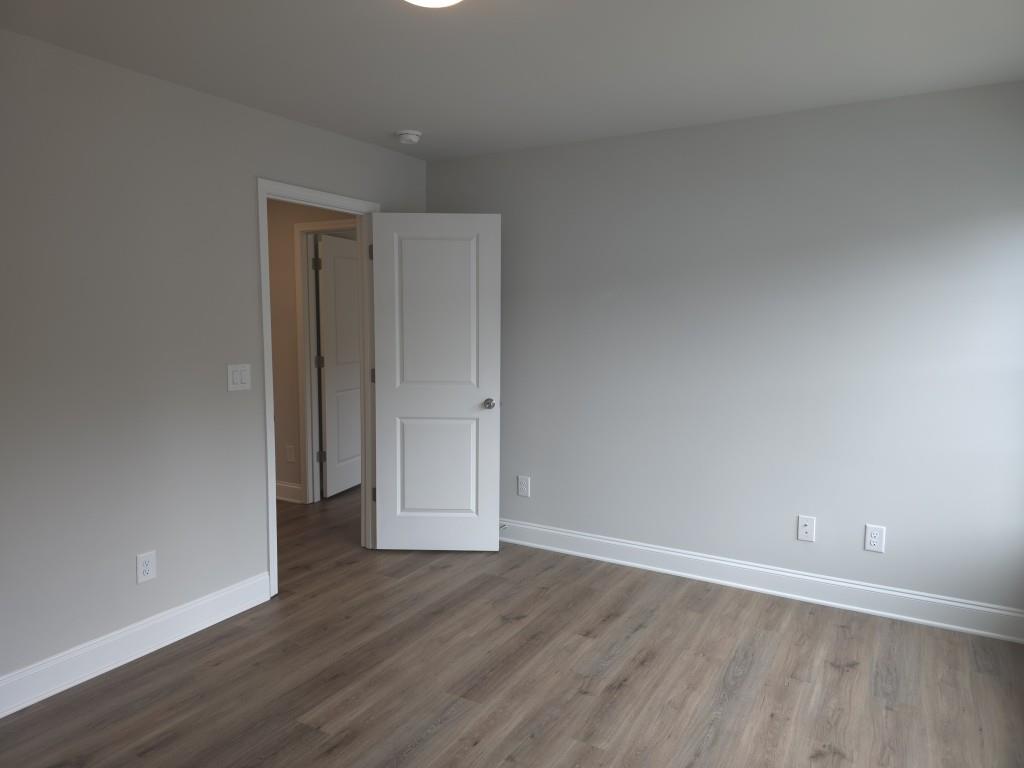 4240 Cavalier Way Duluth, GA 30097 - Photo 22 of 46 a view of an empty room with wooden floor and closet