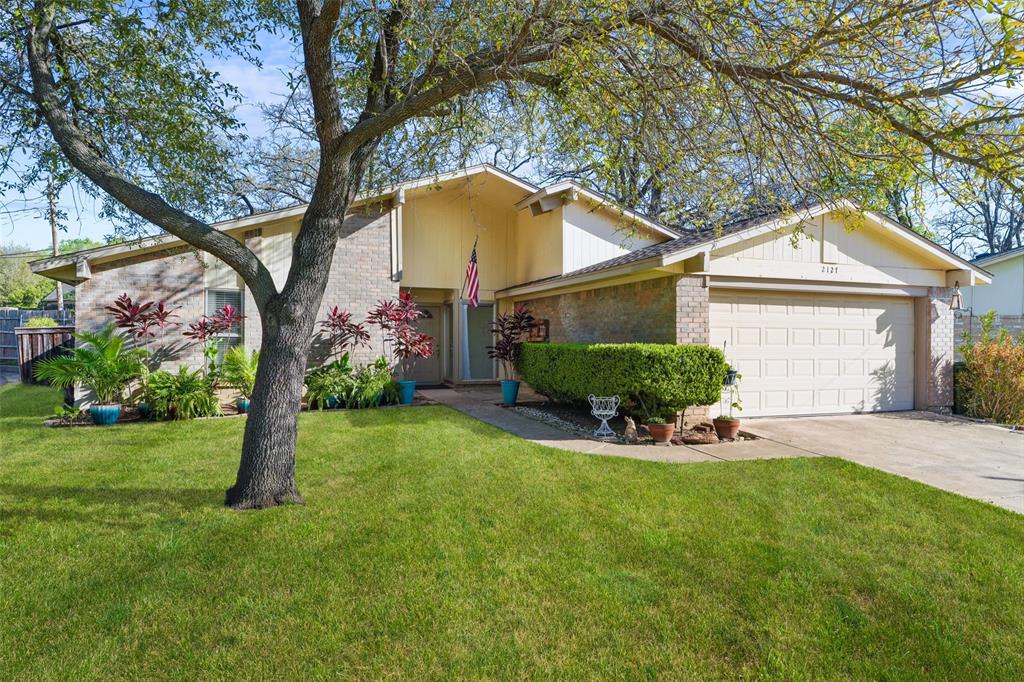 a view of a house with backyard and sitting area