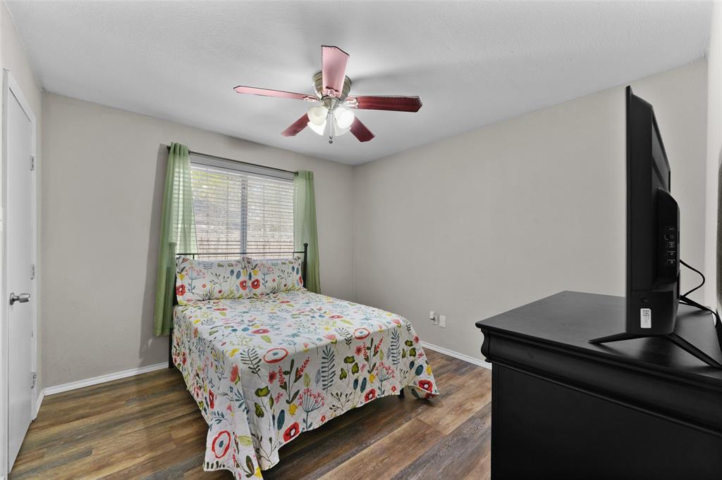 2127 Holt Road Arlington, TX 76006 - Photo 11 of 18 a bedroom with a bed and a flat screen tv