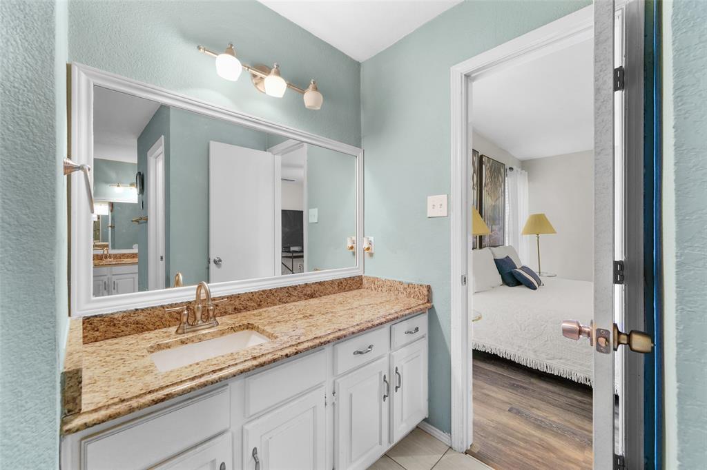 2127 Holt Road Arlington, TX 76006 - Photo 14 of 18 a en suite bathroom with a sink and mirror