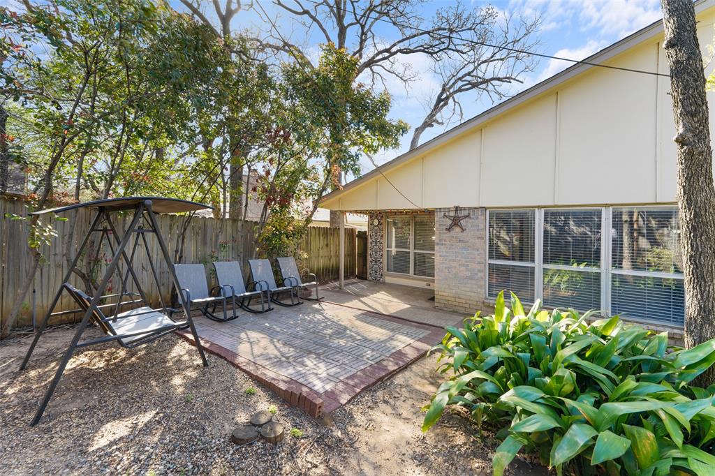 2127 Holt Road Arlington, TX 76006 - Photo 18 of 18 a backyard of a house with table and chairs and wooden fence