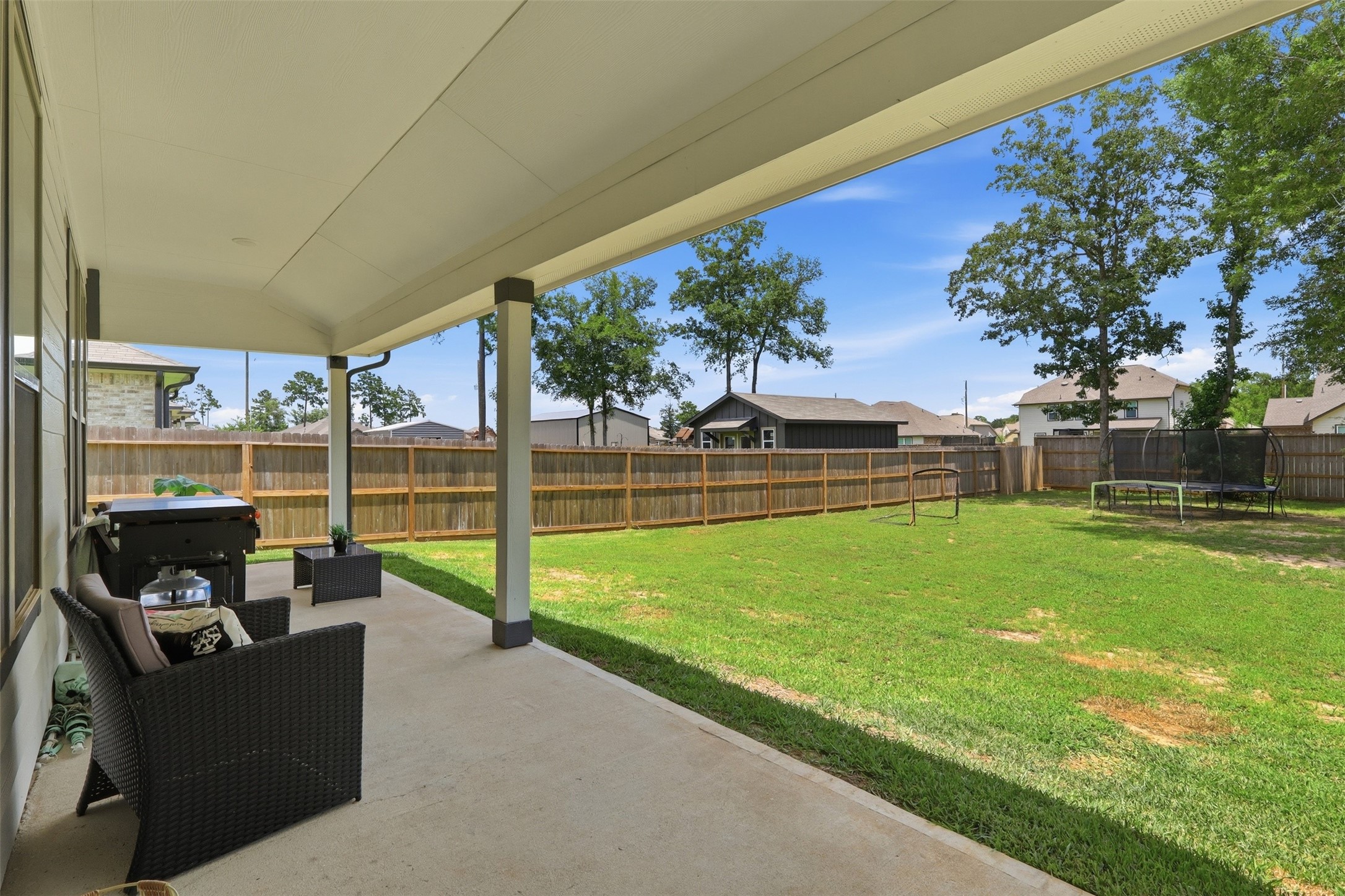 6310 Fawn Path Drive Conroe, TX 77303 - Photo 29 of 41 Expansive backyard featuring an oversized covered patio, plenty of green space, and a fenced yard—perfect for entertaining, relaxing, or creating your dream outdoor oasis.