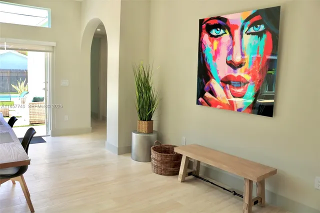 a view of a room with window and potted plant