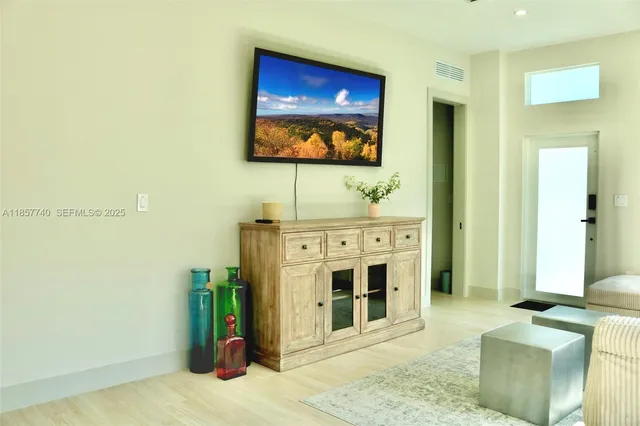 a view of a livingroom with furniture and a window
