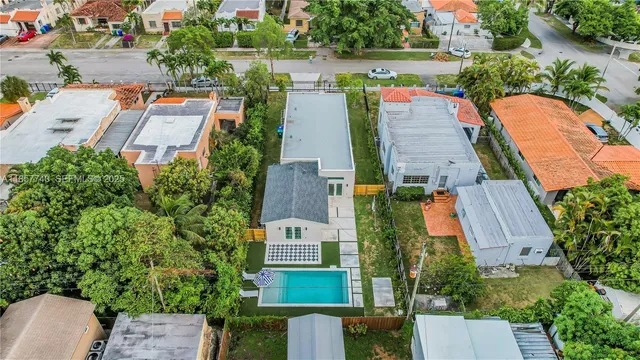 an aerial view of house with yard swimming pool and outdoor seating