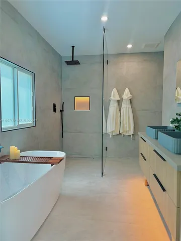a bathroom with a granite countertop sink and a large mirror