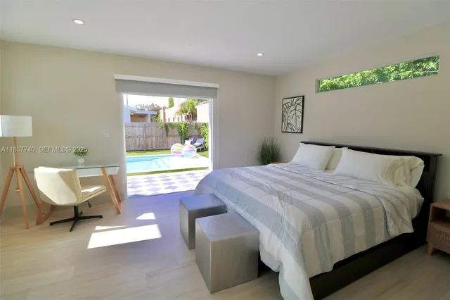 a bedroom with a bed chair and window