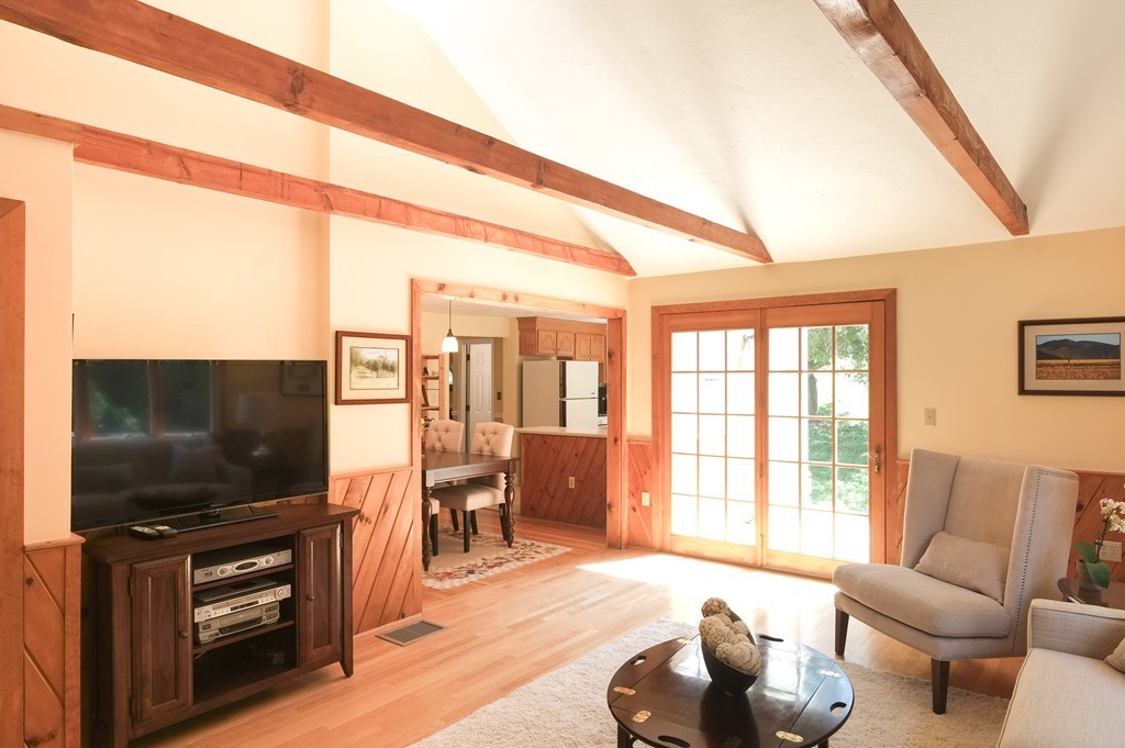 34 Wallace Road Wayland, MA 01778 - Photo 2 of 24 a living room with furniture and a flat screen tv