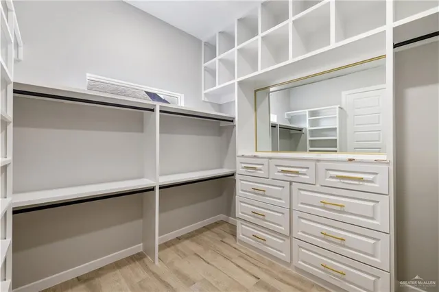 a view of walk in closet with empty racks