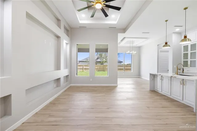 a view of an entryway with wooden floor and a kitchen