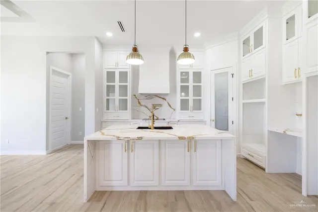 a view of kitchen with center island wooden floor and living room view