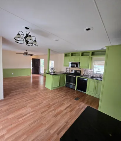 a kitchen with stainless steel appliances kitchen island sink refrigerator and stove