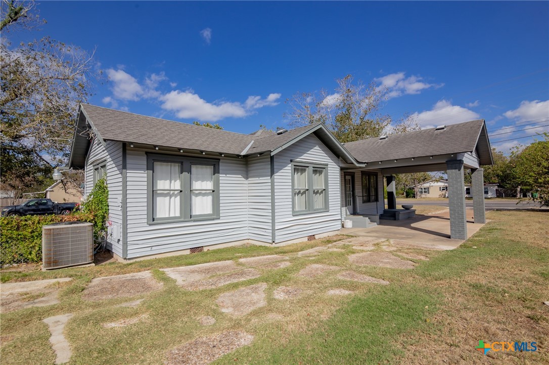 3109 North Main Street Victoria, TX 77901 - Photo 22 of 29 a view of a house with a patio and a yard