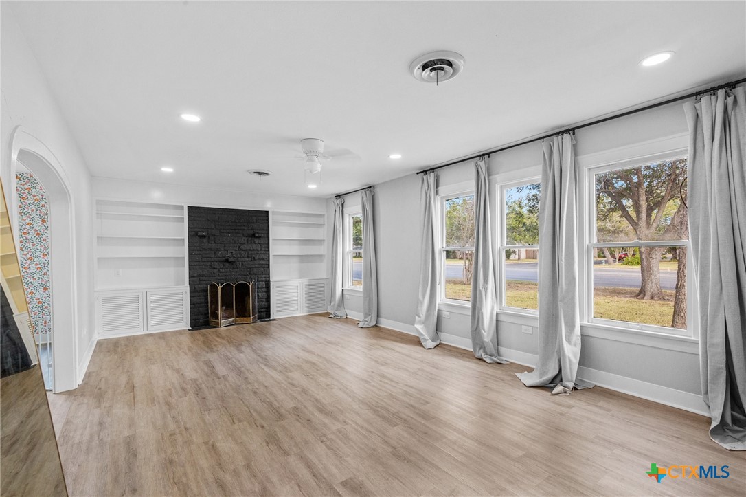 3109 North Main Street Victoria, TX 77901 - Photo 4 of 29 a view of an empty room with a fireplace and a window