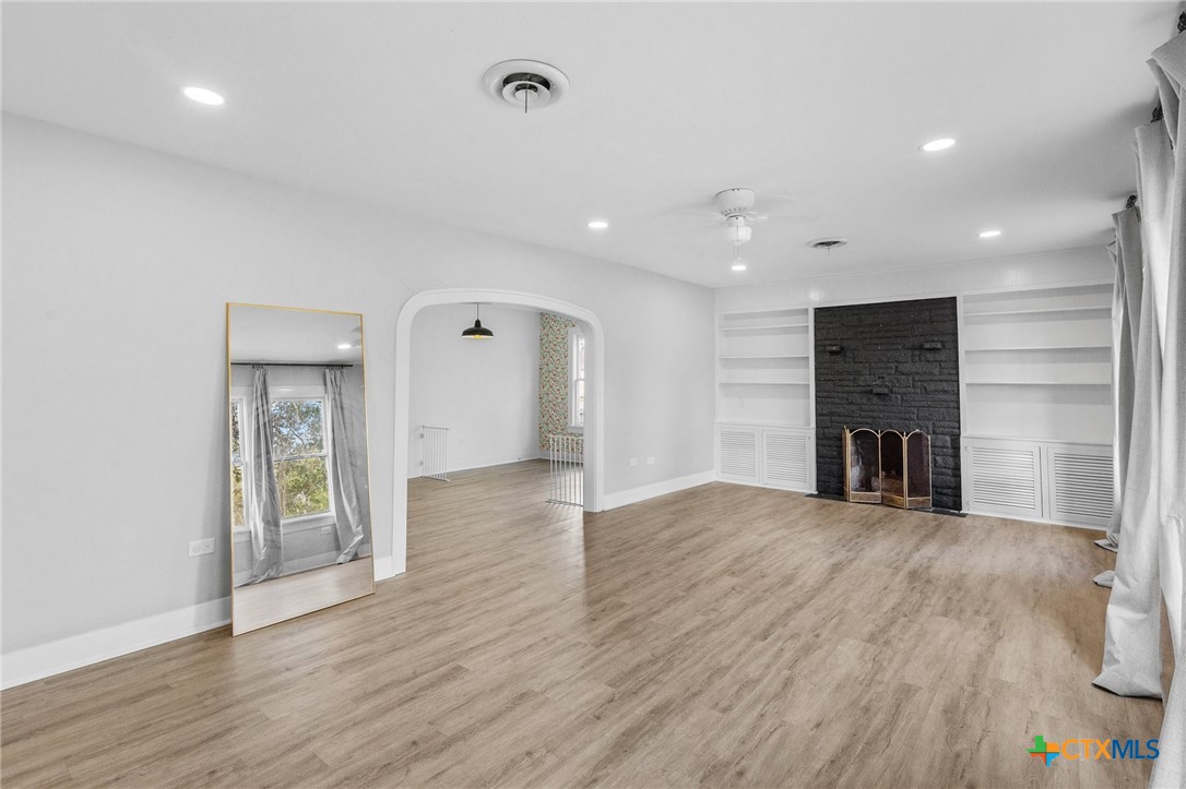 3109 North Main Street Victoria, TX 77901 - Photo 5 of 29 a view of an empty room with wooden floor and a window