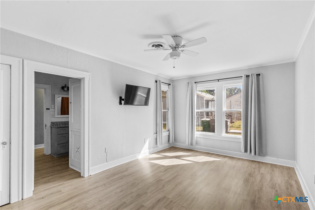 3109 North Main Street Victoria, TX 77901 - Photo 6 of 29 a view of empty room with wooden floor and window
