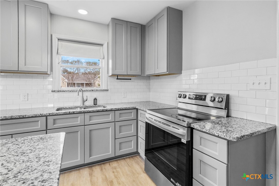 3109 North Main Street Victoria, TX 77901 - Photo 9 of 29 a kitchen with a stove and a sink
