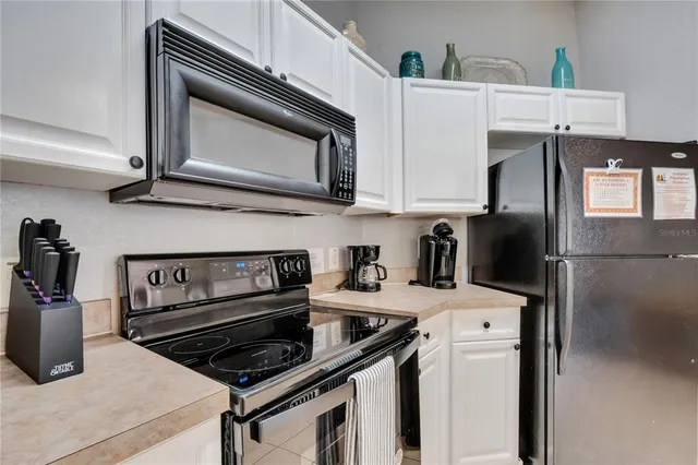 a kitchen with stainless steel appliances a stove a microwave and a refrigerator