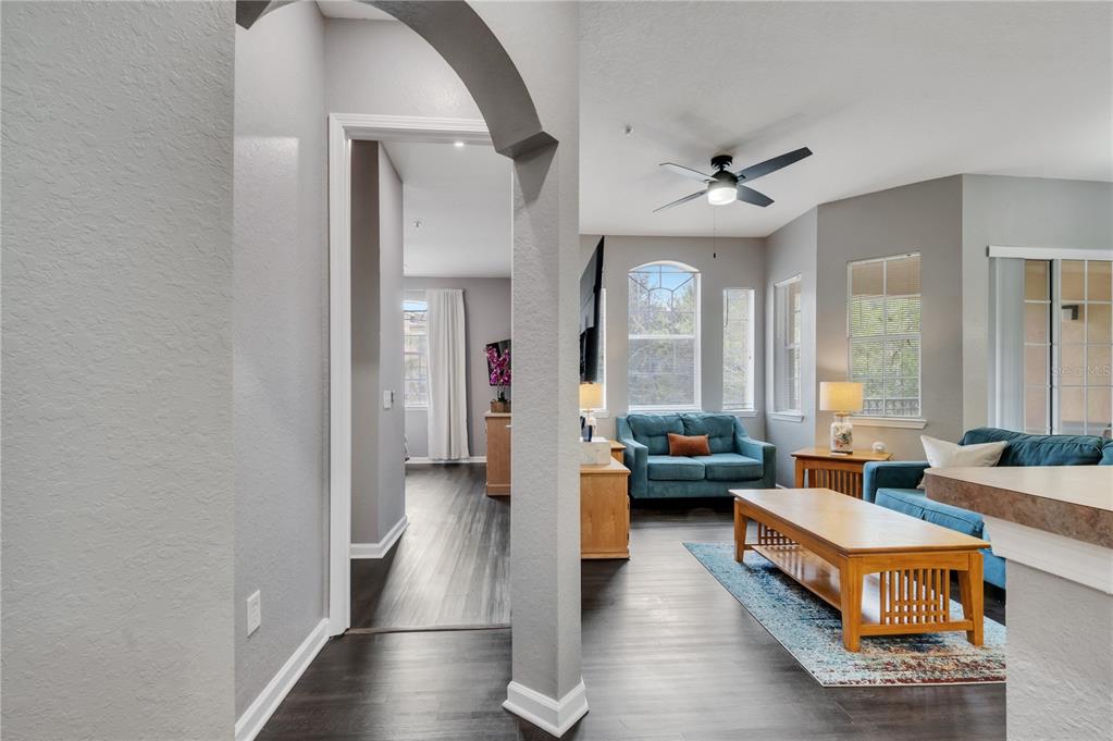 505 Terrace Ridge Circle, Unit 505 Davenport, FL 33896 - Photo 12 of 47 a living room with furniture wooden floor and a chandelier