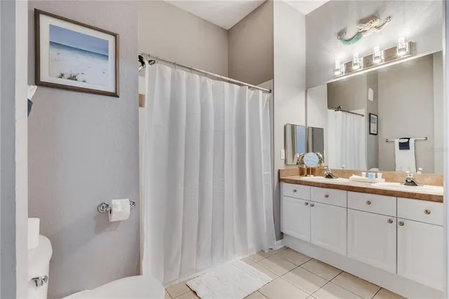 a bathroom with a double vanity sink and mirror