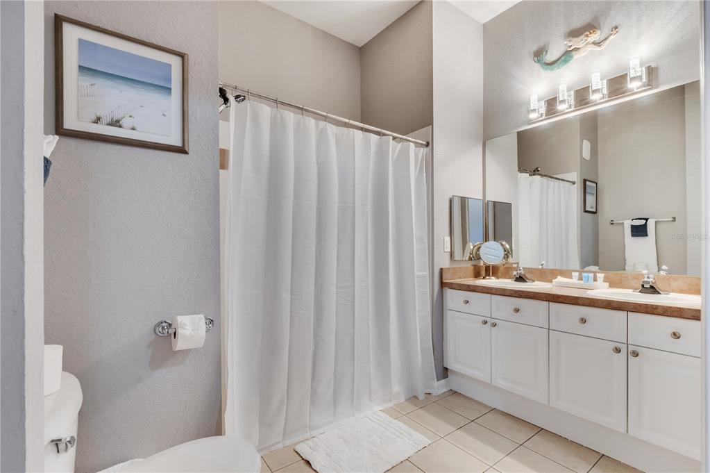 505 Terrace Ridge Circle, Unit 505 Davenport, FL 33896 - Photo 13 of 47 a bathroom with a double vanity sink and mirror
