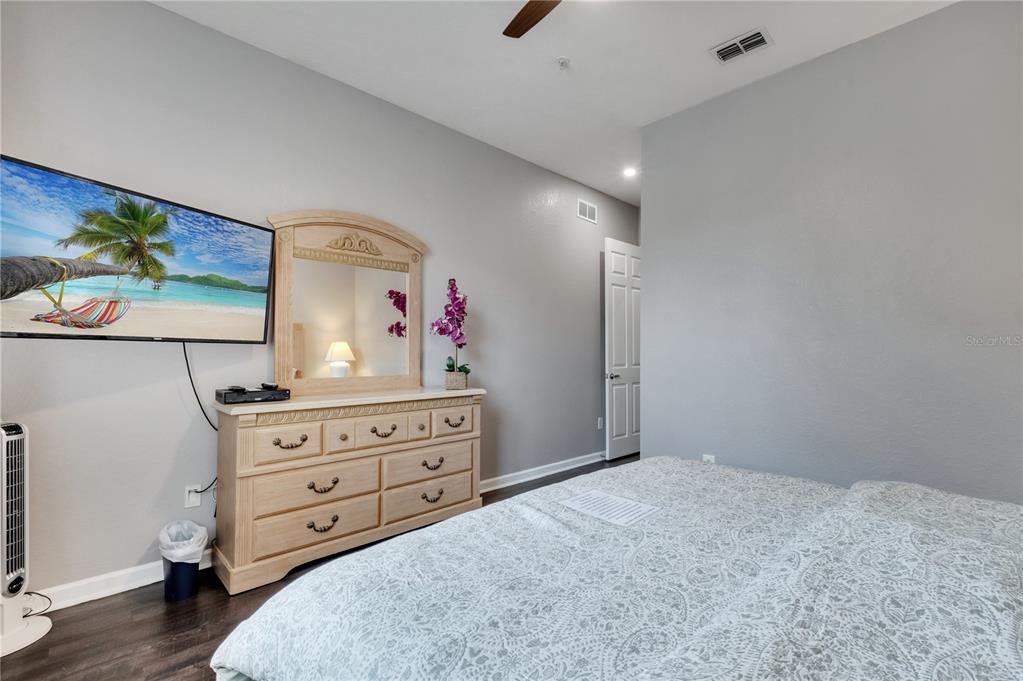 505 Terrace Ridge Circle, Unit 505 Davenport, FL 33896 - Photo 16 of 47 a bed room with a bed and a dresser