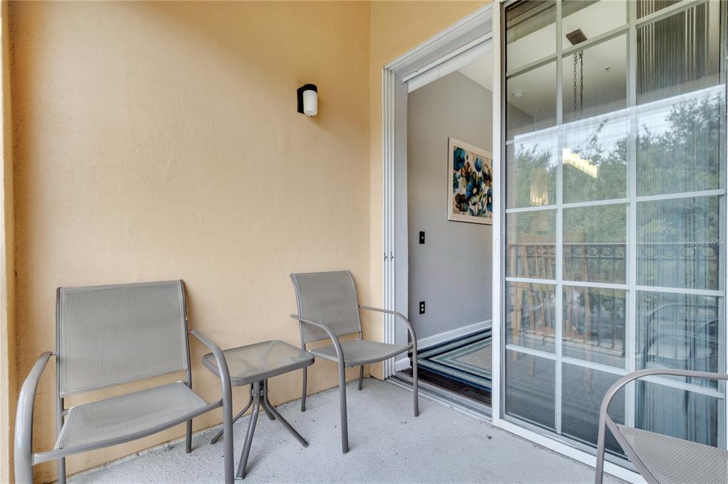 505 Terrace Ridge Circle, Unit 505 Davenport, FL 33896 - Photo 24 of 47 a room that has a bed and a chair in it