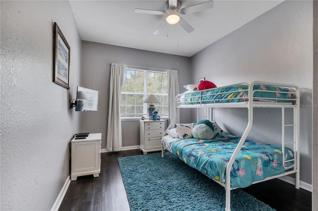 505 Terrace Ridge Circle, Unit 505 Davenport, FL 33896 - Photo 31 of 47 a bedroom with a bed and wooden floor