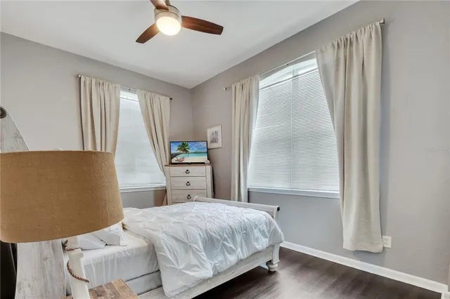 a bedroom with a bed and a television