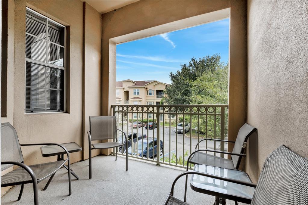 505 Terrace Ridge Circle, Unit 505 Davenport, FL 33896 - Photo 5 of 47 a view of a balcony with chairs