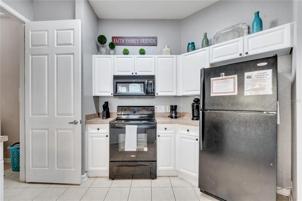 505 Terrace Ridge Circle, Unit 505 Davenport, FL 33896 - Photo 6 of 47 a kitchen with stainless steel appliances a refrigerator sink and cabinets