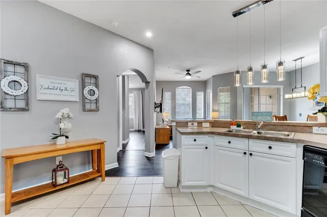 a spacious bathroom with a granite countertop sink a mirror and shower